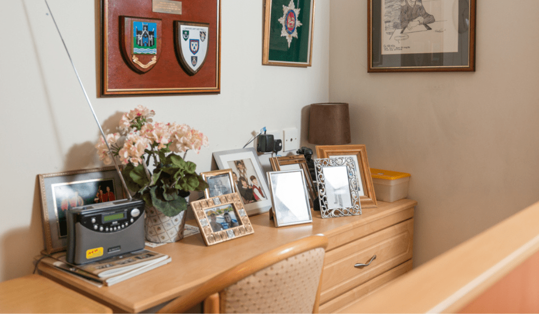 care home bedroom with desk of photos to help with benefits of reminiscence therapy